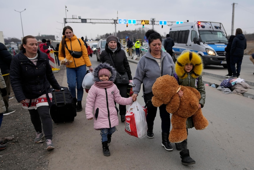 People from Ukraine arrive at a border crossing in Poland