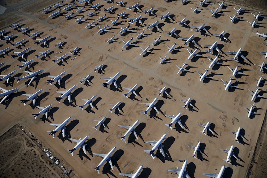 Planes parked on the red sand of the American desert.