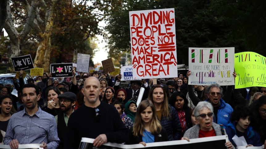 Protesters demonstrate near Pittsburgh's Tree of Life Synagogue as Donald Trump visits.