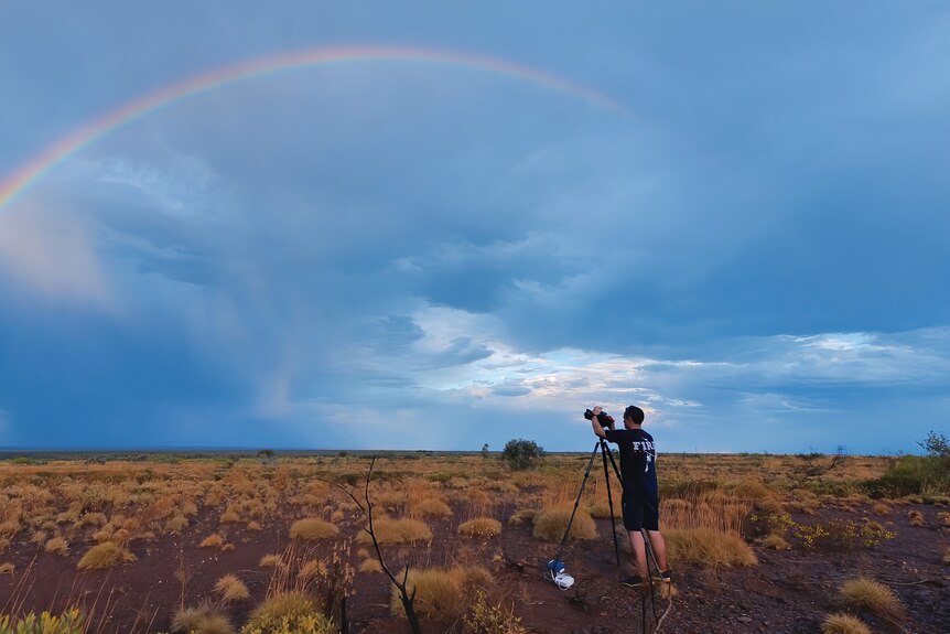 Jordan is pointing his camera towards a rainbow