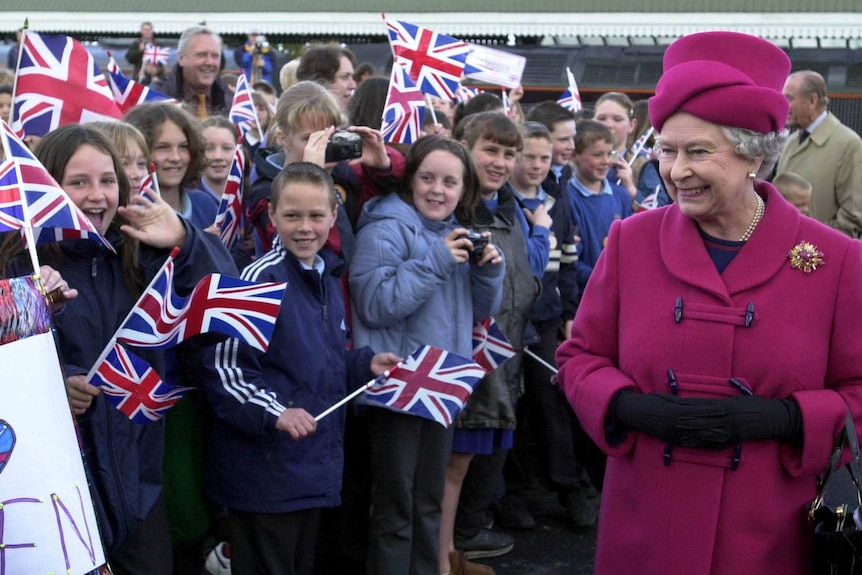 Britain's Queen Elizabeth II smiles at wellwishers at the beginning of her nationwide Golden Jubilee tour, May 1, 2002