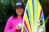 Pauline Menczer with a medal and surfboard