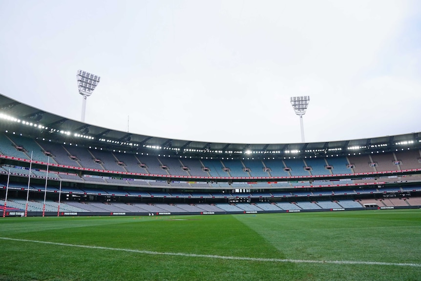 A view of an empty stadium, looking a cross the ground with goalposts on the far left.