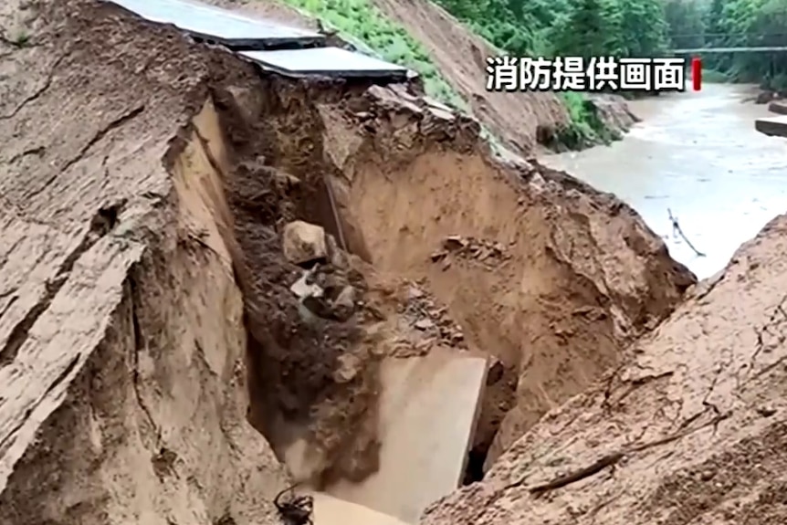 A road collapses after landslides around it.