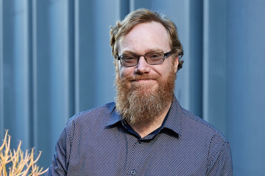 Colour photograph of Australia author Ryan O'Neill standing on a city rooftop.