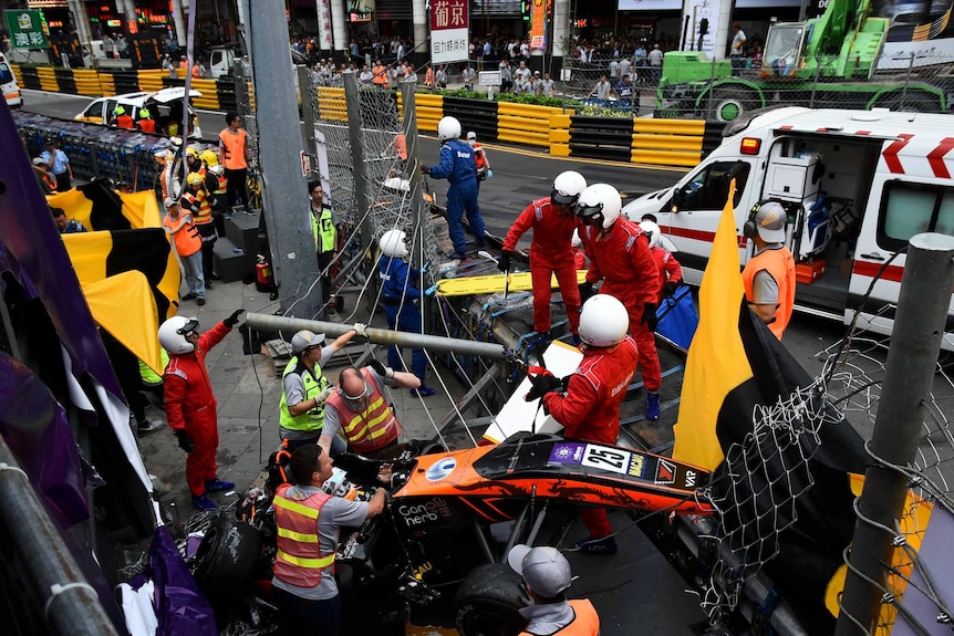 Sophia Floersch sits in her car after crashing through a barrier. Marshals see to her.