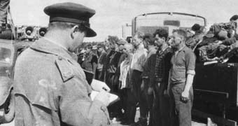 War artist Alan Moore sketching at concentration camp