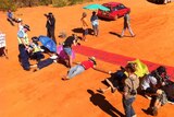 The media takes photos of gas hub protesters lying on the ground