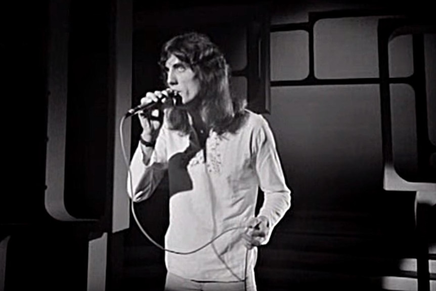 Black and white TV still of Jon English sing during a TV performance in 1972.