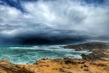 Ominous dark storm clouds over a churning ocean