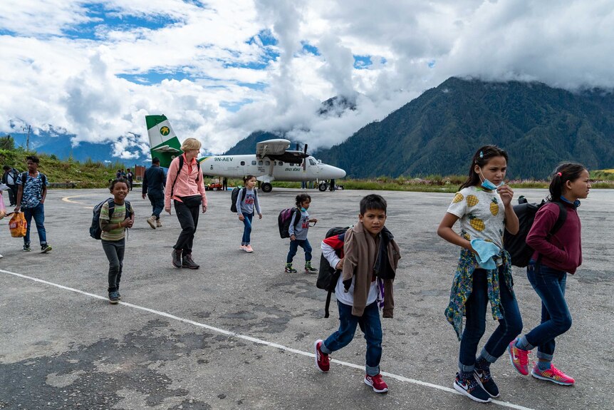 Children walk across the tarmac at Simikot Airport.
