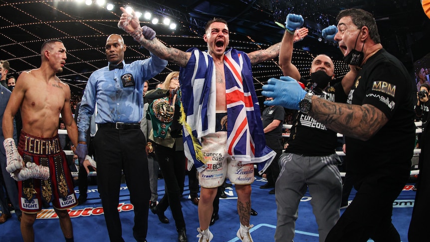 George Kambosos Jr has his hand raised in the arm as he becomes the World Lightweight champion