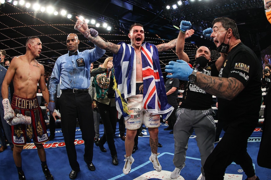 George Kambosos Jr has his hand raised in the arm as he becomes the World Lightweight champion