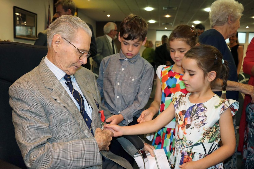 Frederick Cox shows the award to his grandchildren Finn, Fenella and Jessie Cox.
