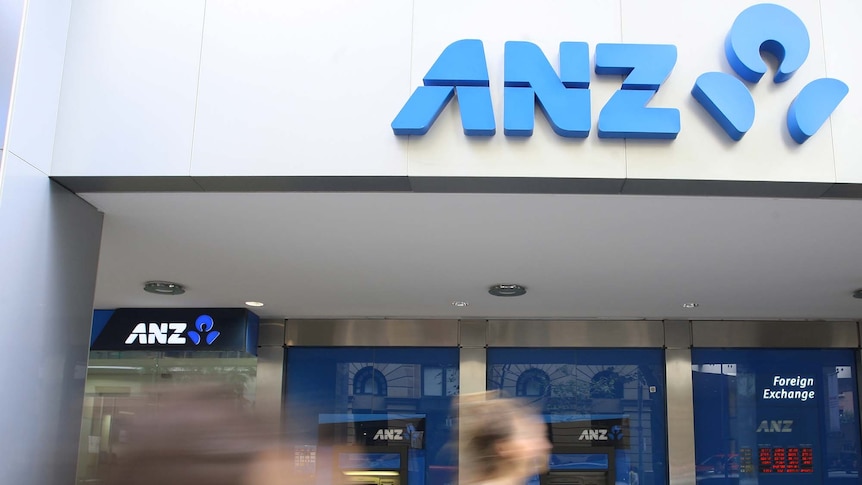 Pedestrians walk past ANZ bank in Sydney