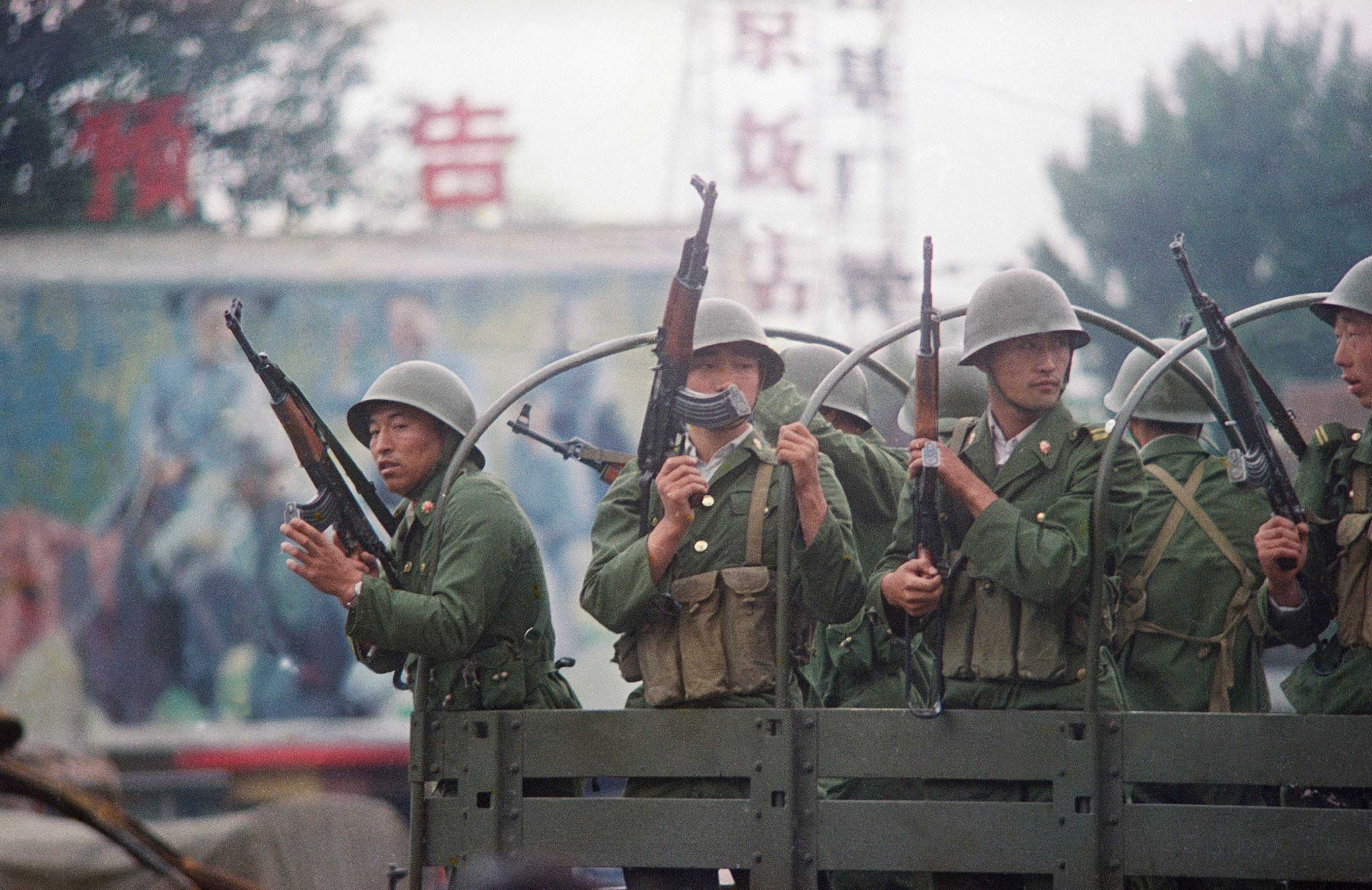 Chinese troops patrol a major road in Beijing just days after the Tiananmen massacre.