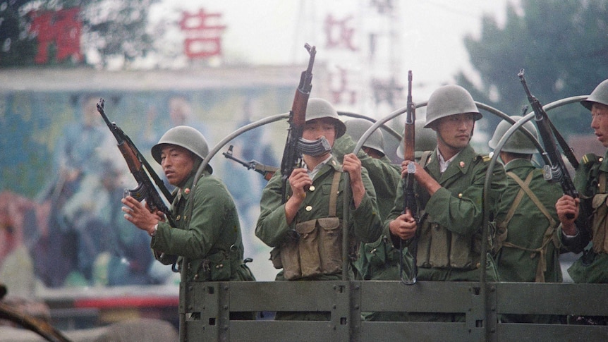 Chinese troops patrol a major road in Beijing just days after the Tiananmen massacre.