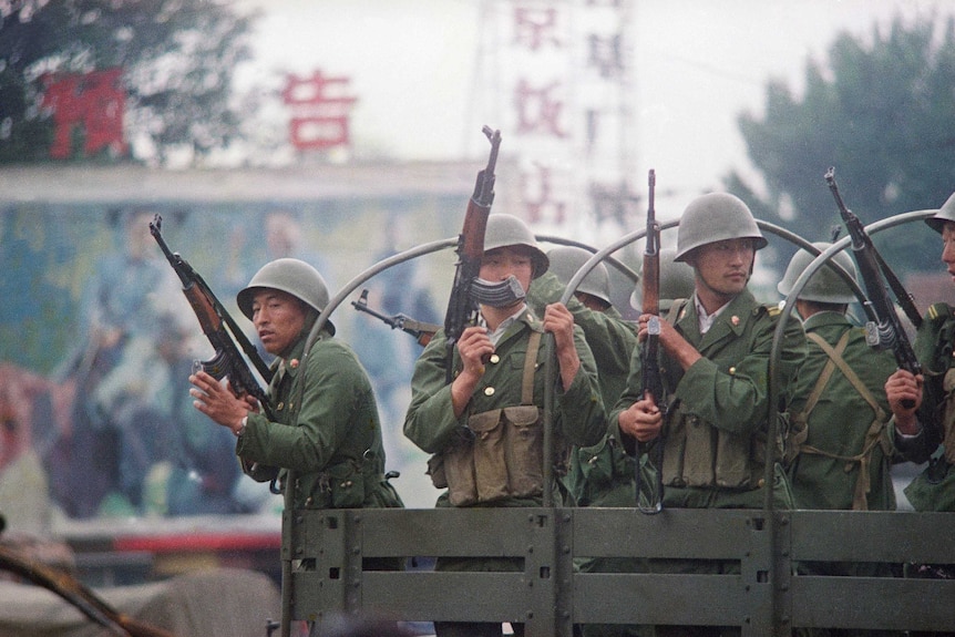 Chinese troops patrol a major road in Beijing just days after the Tiananmen massacre.
