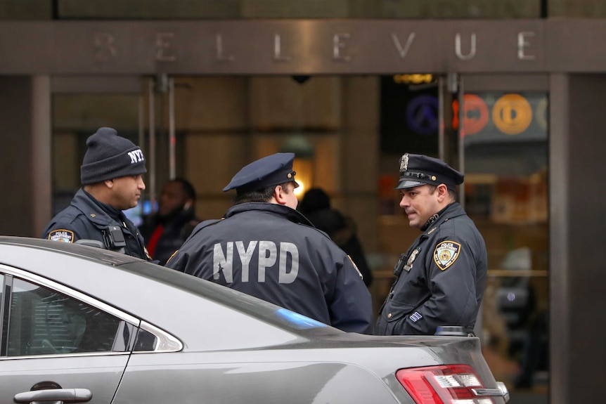 New York police officers stand outside Bellevue Hospital Centre