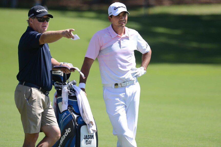 Australian golfer Jason Day (R) with his caddy Col Swatton (L) ahead of the 2013 Australian Open.