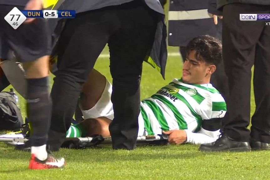 Daniel Arzani is stretchered off after injuring his knee in Celtic's game against Dundee.
