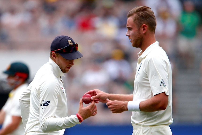 Joe Root looks at the ball in Stuart Broad's hand
