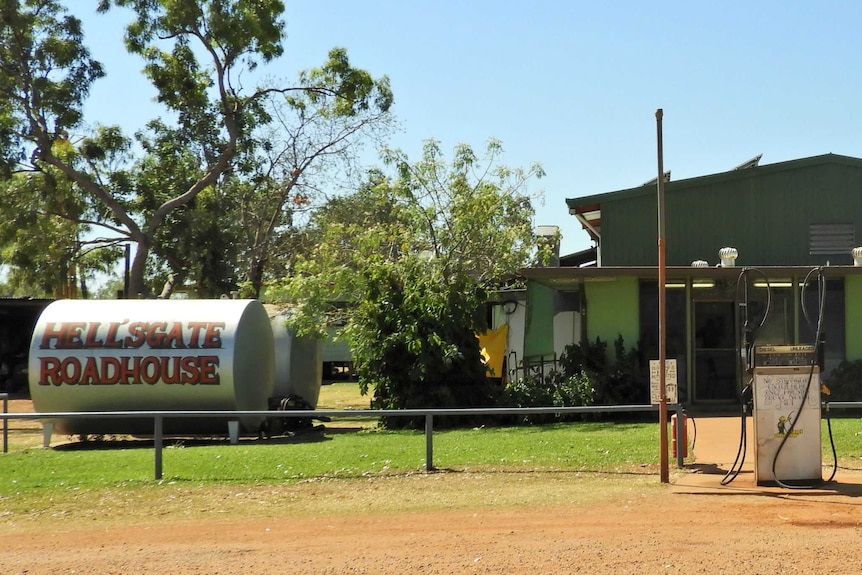 Front of a roadhouse with big tank and petrol bowser
