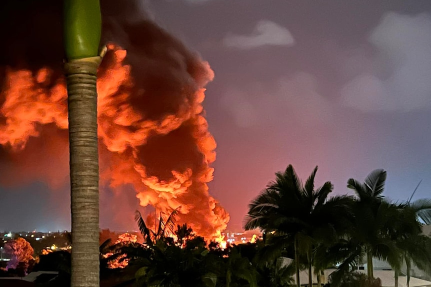 Red-tinted smoke billowing in distance