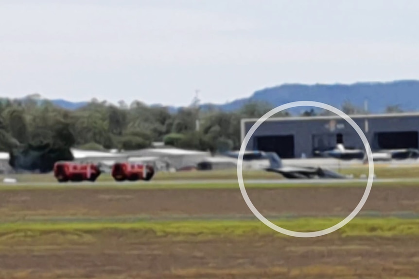 A plane sits with its nose touching the runway