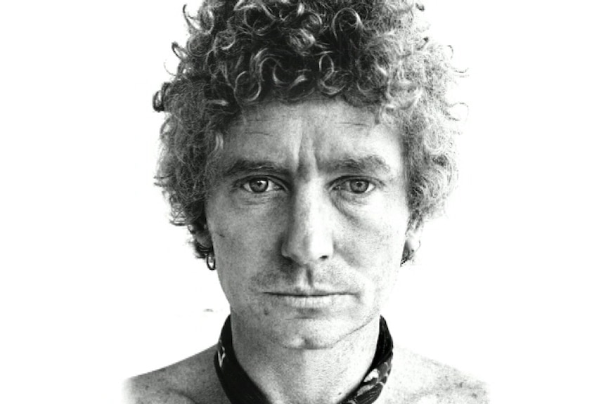 A black and white photo of Brett Whiteley, he is staring into the camera.