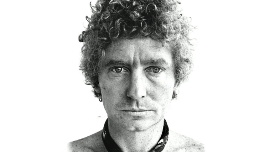 A black and white photo of Brett Whiteley, he is staring into the camera.