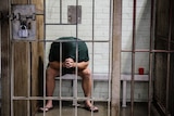 Prison inmate behind bars