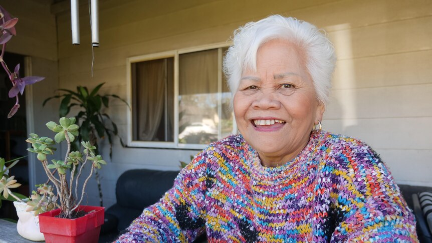 Rebecca Macdonald smiling standing on her front porch