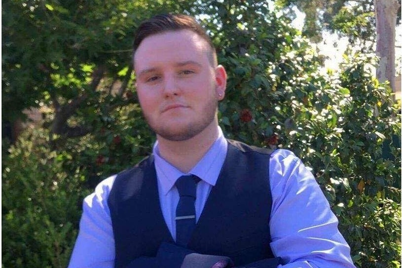 young man in suit looking into the camera