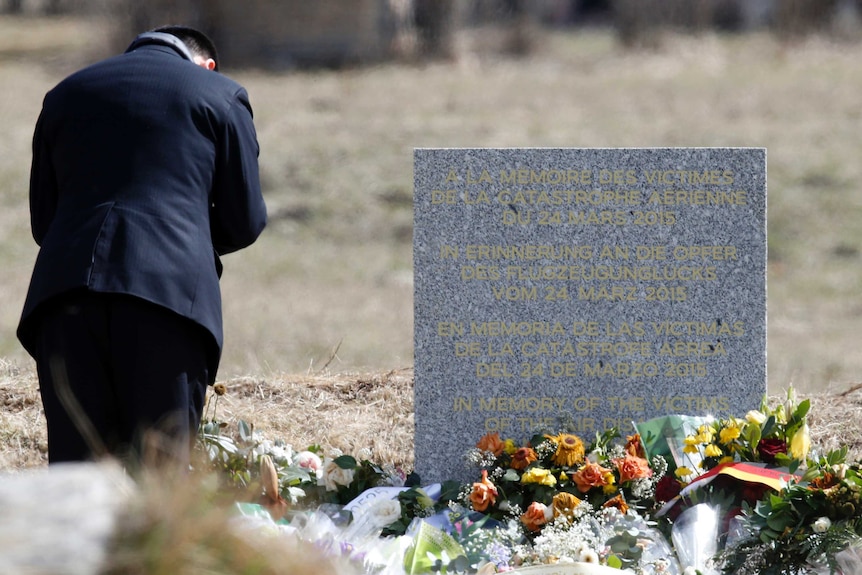 A man pays his respects at the memorial