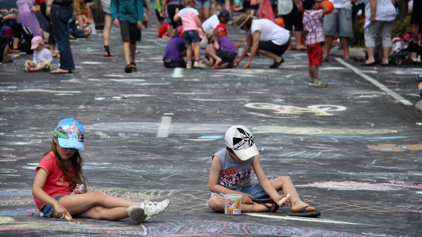 Children get creative in Ruthven Street during the Carnival of Flowers in Toowoomba.