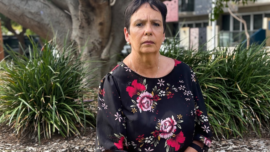 Karen Jones sits under a tree in the Karratha town centre. 