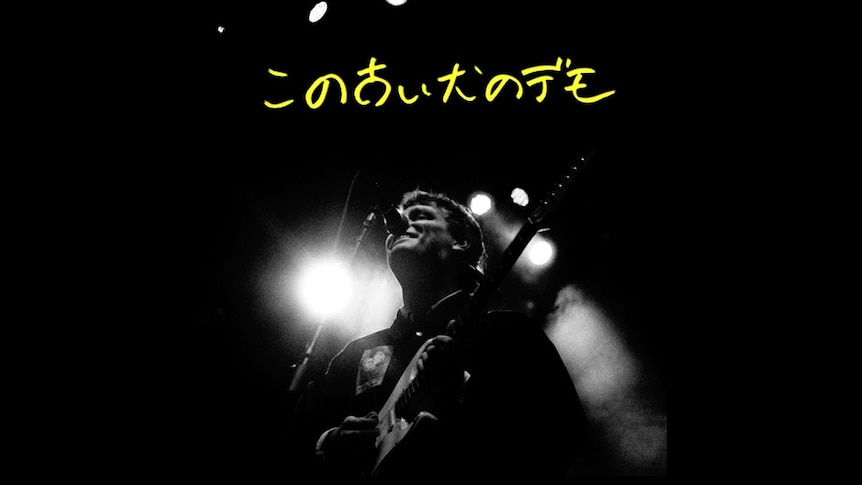 Album cover for Mac DeMarcos 'Old Dog Demos' black and white image of Mac playing guitar, Japanese text in yellow
