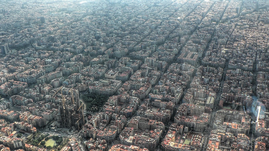 Dozens of blocks of mid-height apartment buildings with the city's cathedral in shot.