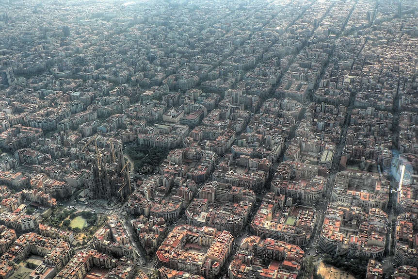 Dozens of blocks of mid-height apartment buildings with the city's cathedral in shot.