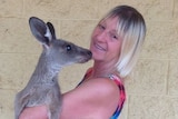 Millmerran woman Linda Smith holding a small kangaroo.