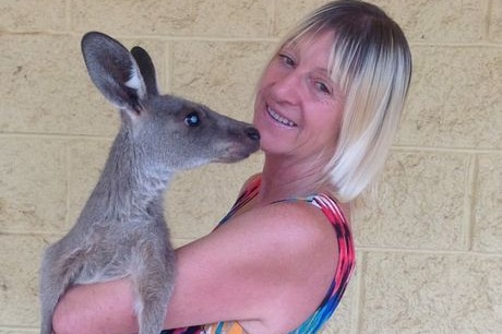 Millmerran woman Linda Smith holding a small kangaroo.