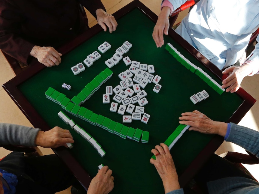 Mahjong tiles lay on the table.