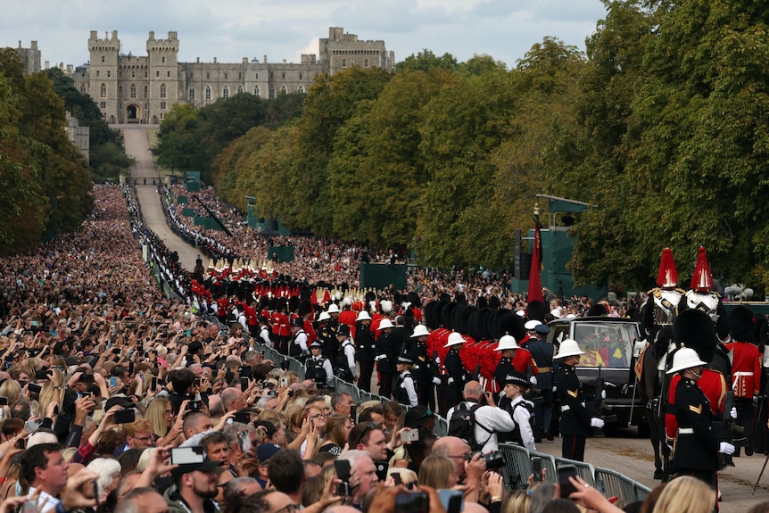 The hearse carrying Queen Elizabeth's coffin is escorted down the Long Walk.