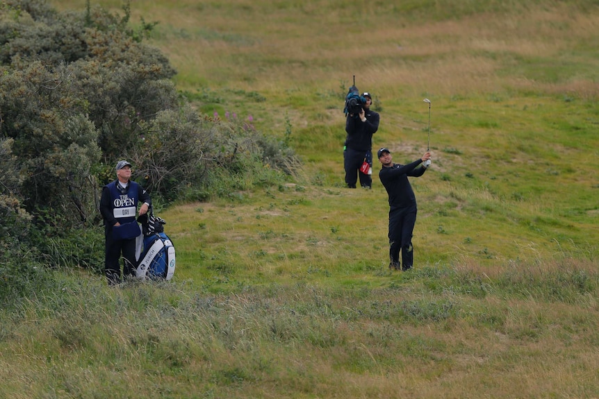 Jason Day hits out of the rough at British Open