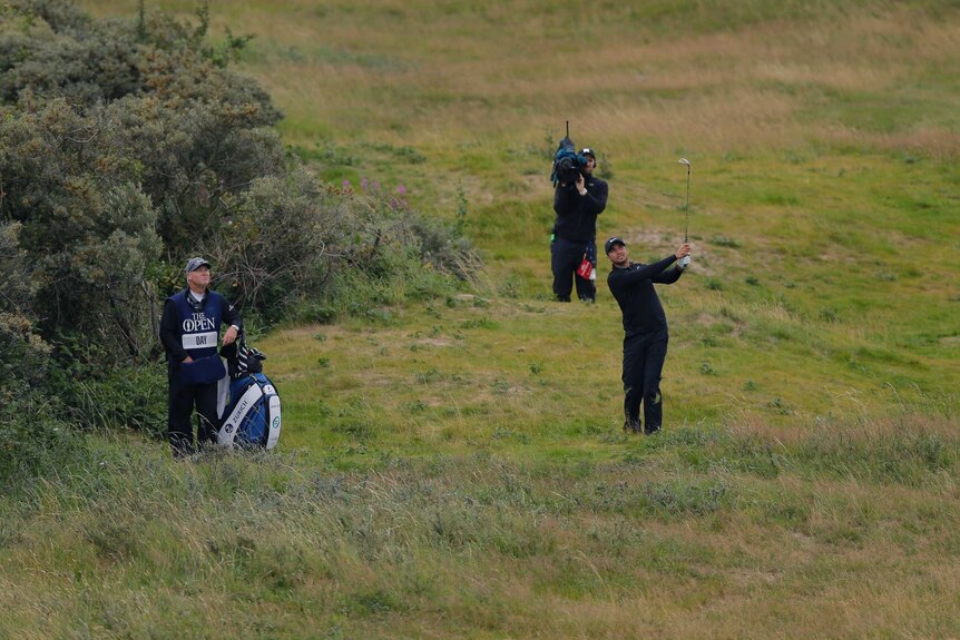 Jason Day hits out of the rough at British Open