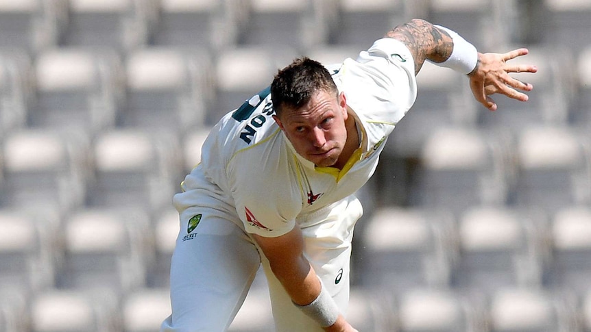 James Pattinson bends his back as he follows the ball with his eye while bowling