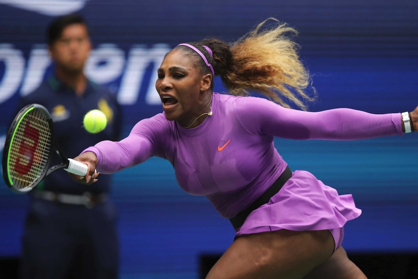 Serena Williams stretches to make a forehand
