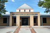 A light brick school building entrance.