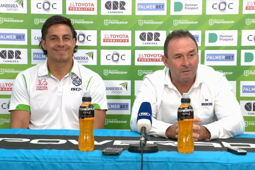 Joe Tapine smiles as Ricky Stuart talks in a post-match press conference.